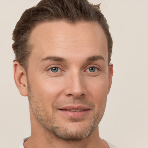 Joyful white young-adult male with short  brown hair and brown eyes