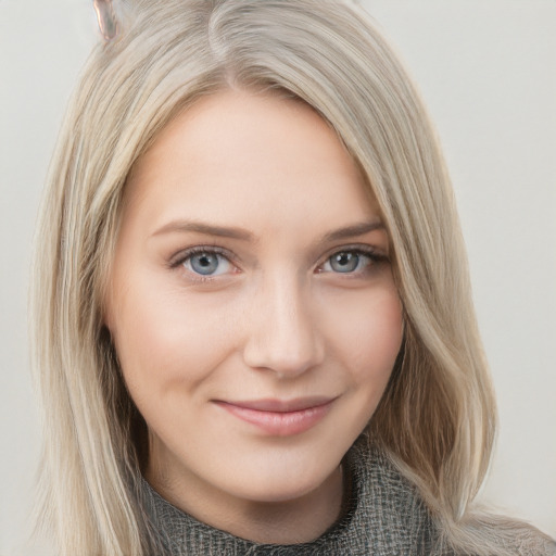 Joyful white young-adult female with long  brown hair and blue eyes