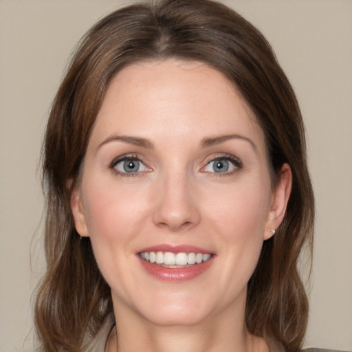 Joyful white young-adult female with medium  brown hair and blue eyes