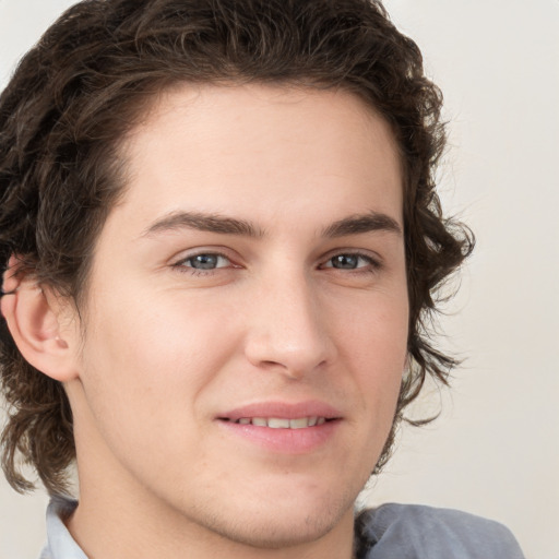 Joyful white young-adult male with medium  brown hair and brown eyes