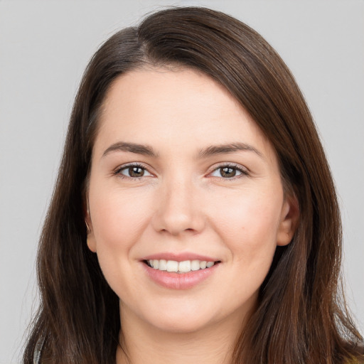 Joyful white young-adult female with long  brown hair and brown eyes