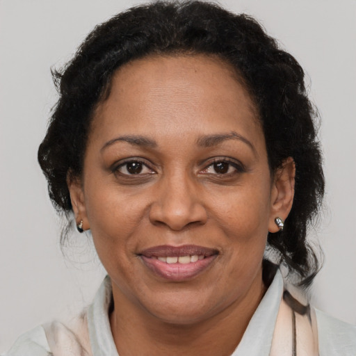 Joyful latino adult female with short  brown hair and brown eyes