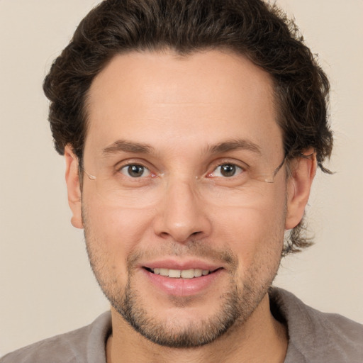 Joyful white adult male with short  brown hair and brown eyes