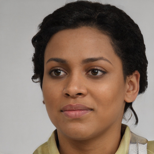 Joyful black young-adult female with medium  black hair and brown eyes