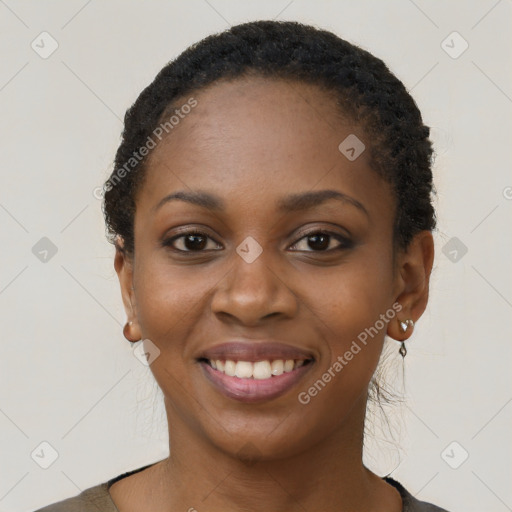 Joyful black young-adult female with short  black hair and brown eyes