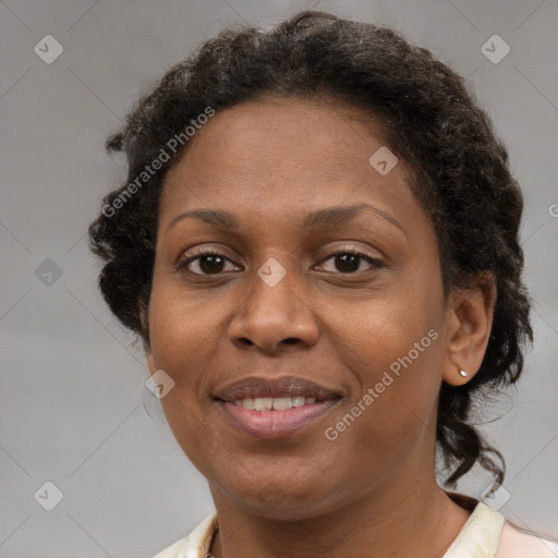 Joyful black adult female with medium  brown hair and brown eyes