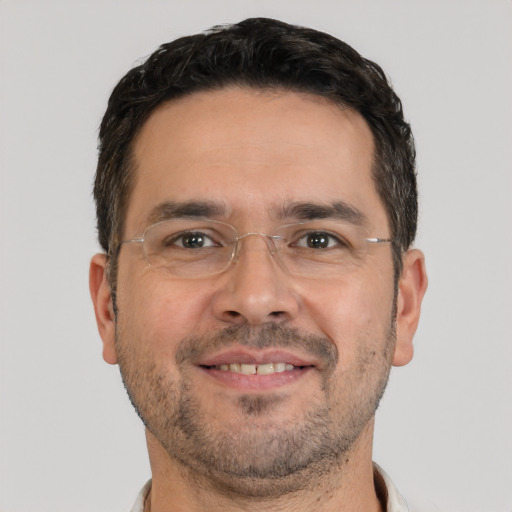 Joyful white adult male with short  brown hair and brown eyes