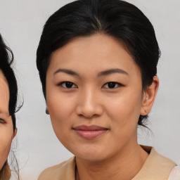 Joyful asian young-adult female with medium  brown hair and brown eyes