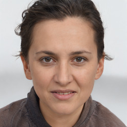 Joyful white adult female with short  brown hair and brown eyes