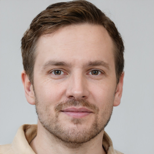 Joyful white adult male with short  brown hair and grey eyes