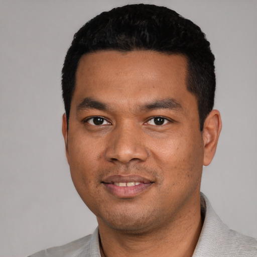Joyful asian young-adult male with short  black hair and brown eyes