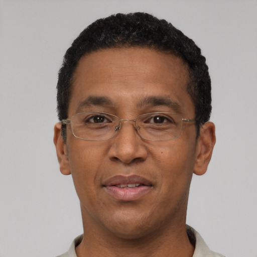 Joyful black adult male with short  black hair and brown eyes