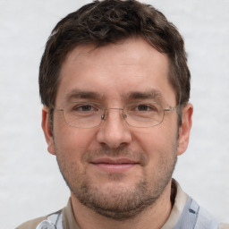 Joyful white adult male with short  brown hair and grey eyes