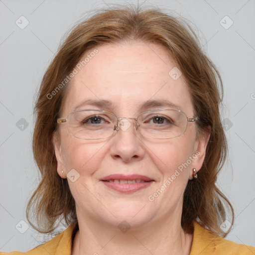 Joyful white adult female with medium  brown hair and blue eyes