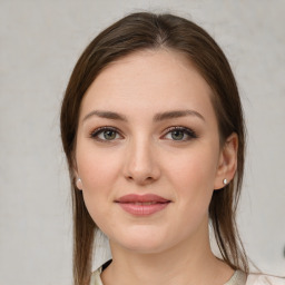 Joyful white young-adult female with medium  brown hair and green eyes