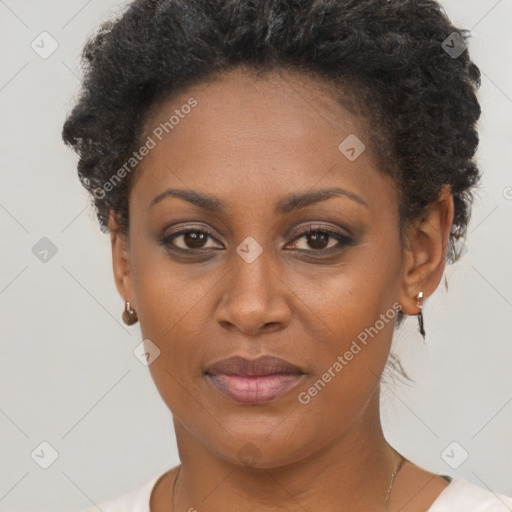 Joyful black adult female with short  brown hair and brown eyes