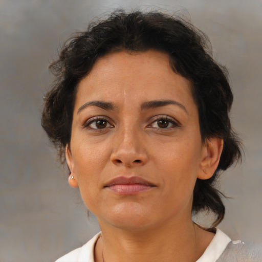 Neutral latino adult female with medium  brown hair and brown eyes