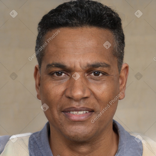 Joyful black adult male with short  black hair and brown eyes