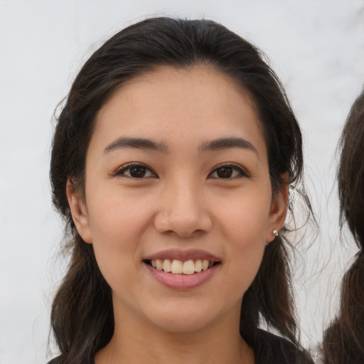 Joyful white young-adult female with medium  brown hair and brown eyes