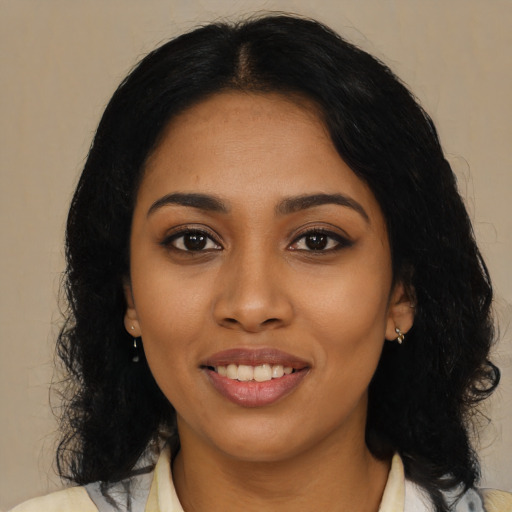 Joyful black young-adult female with medium  black hair and brown eyes