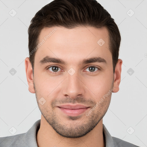 Joyful white young-adult male with short  brown hair and brown eyes