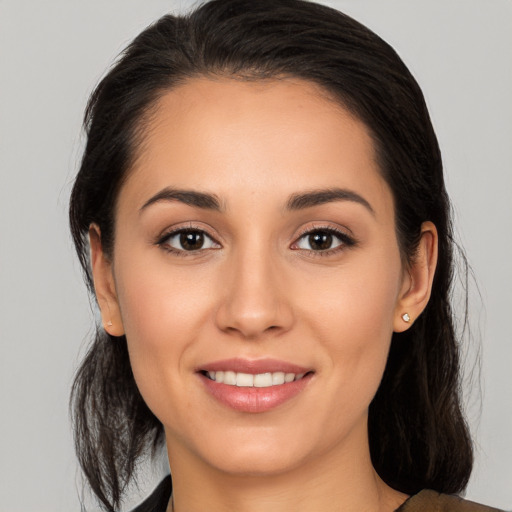 Joyful white young-adult female with medium  black hair and brown eyes