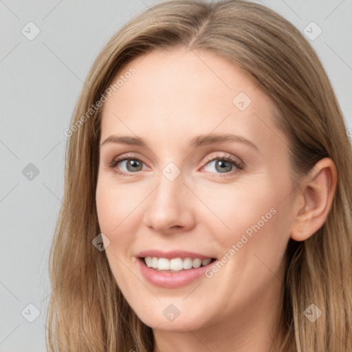 Joyful white young-adult female with long  brown hair and blue eyes