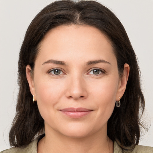 Joyful white young-adult female with medium  brown hair and brown eyes