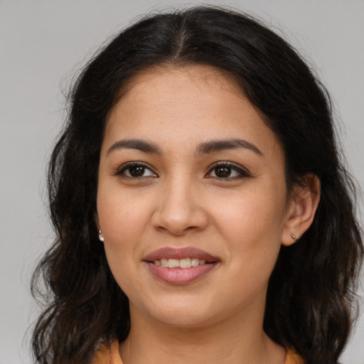 Joyful latino young-adult female with long  brown hair and brown eyes