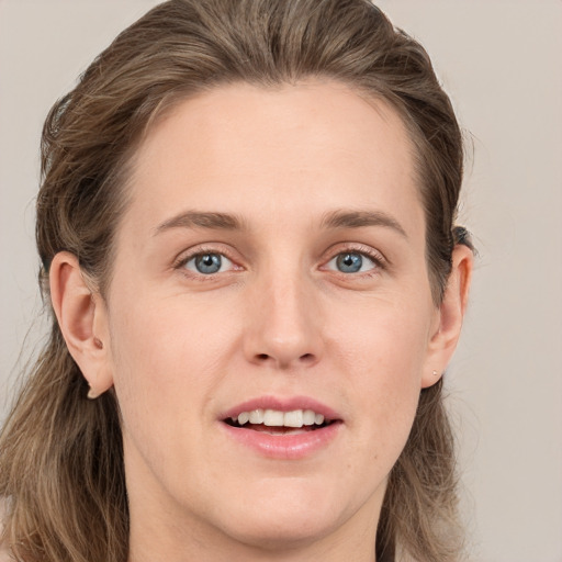 Joyful white young-adult female with long  brown hair and grey eyes