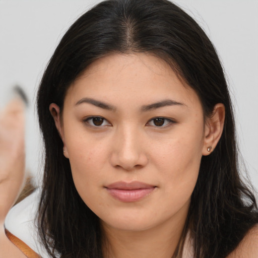 Joyful asian young-adult female with long  brown hair and brown eyes