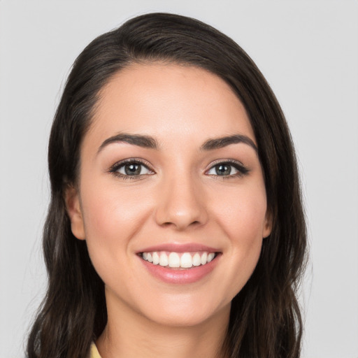 Joyful white young-adult female with long  brown hair and brown eyes