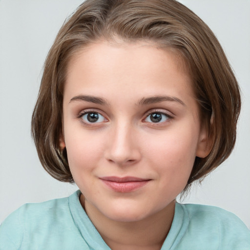 Joyful white child female with medium  brown hair and blue eyes