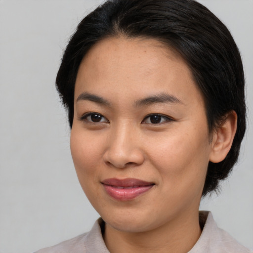 Joyful asian young-adult female with medium  black hair and brown eyes