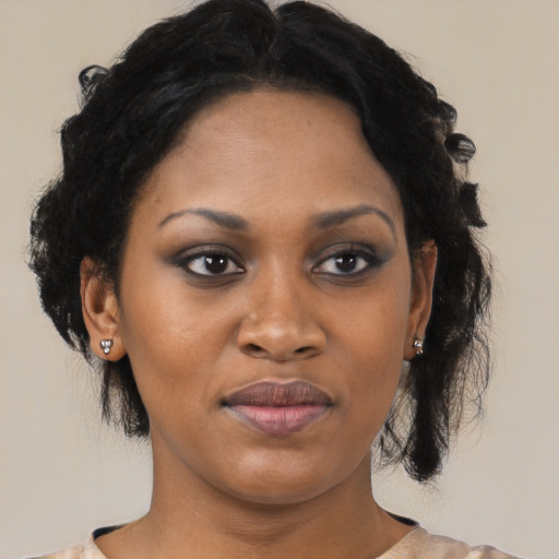 Joyful black young-adult female with medium  brown hair and brown eyes