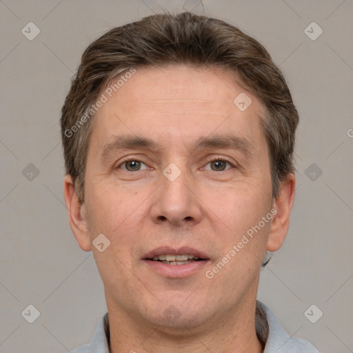 Joyful white adult male with short  brown hair and grey eyes