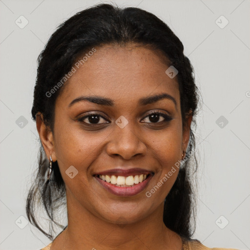 Joyful black young-adult female with long  black hair and brown eyes