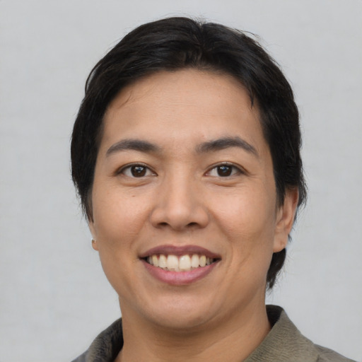 Joyful asian young-adult female with short  black hair and brown eyes