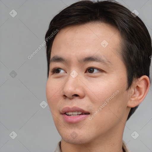 Joyful asian young-adult male with short  brown hair and brown eyes