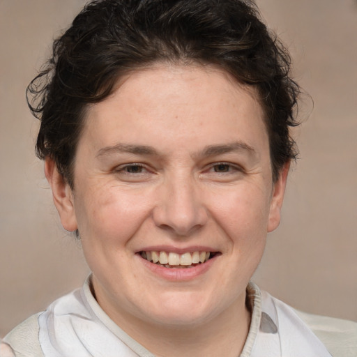 Joyful white adult female with short  brown hair and brown eyes