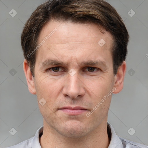 Joyful white adult male with short  brown hair and grey eyes