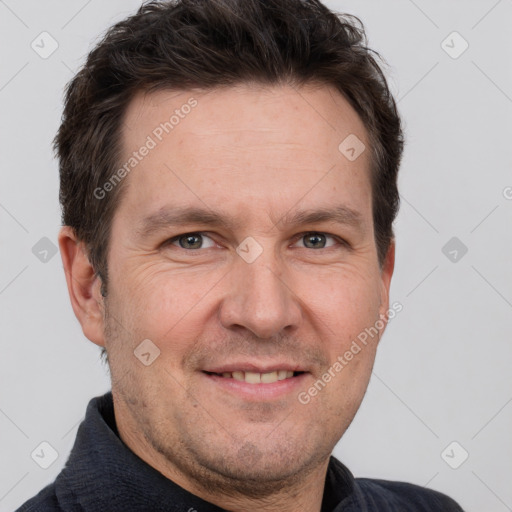 Joyful white adult male with short  brown hair and grey eyes