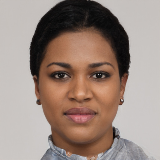 Joyful black young-adult female with short  black hair and brown eyes