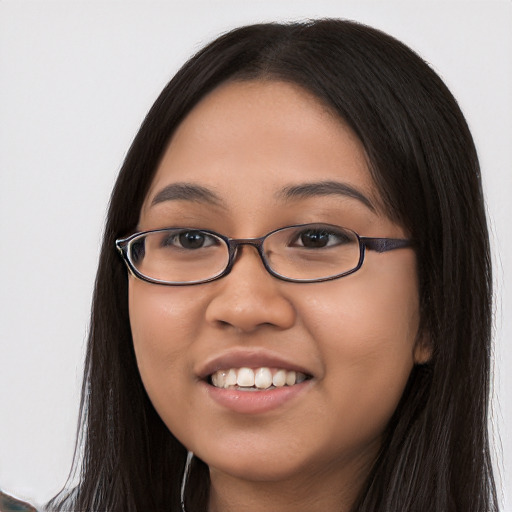 Joyful latino young-adult female with long  black hair and brown eyes