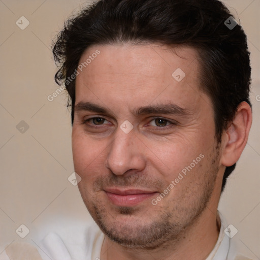 Joyful white adult male with short  brown hair and brown eyes