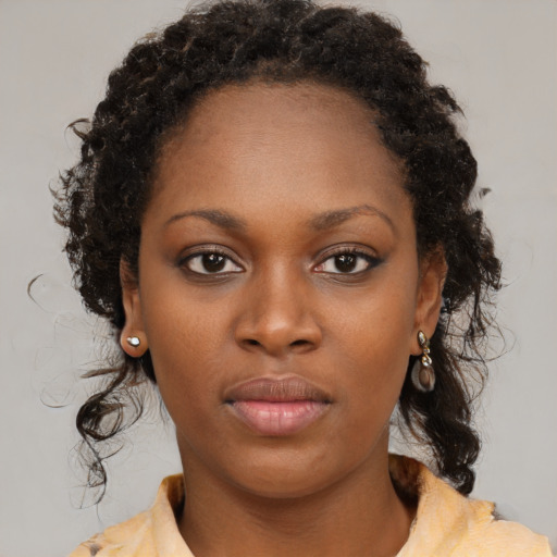 Neutral black young-adult female with medium  brown hair and brown eyes