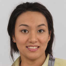 Joyful latino young-adult female with medium  brown hair and brown eyes