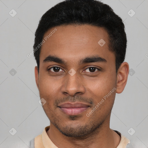 Joyful black young-adult male with short  black hair and brown eyes