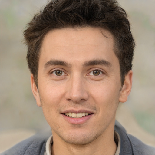 Joyful white adult male with short  brown hair and brown eyes