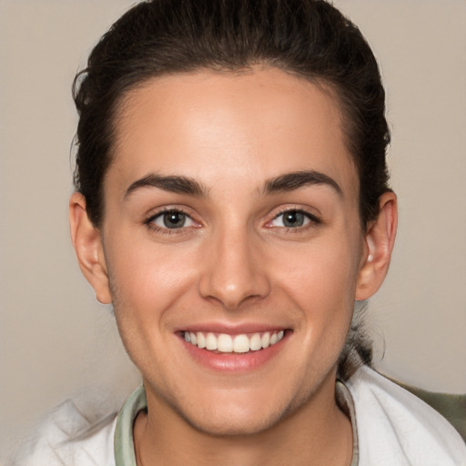 Joyful white young-adult female with short  brown hair and brown eyes